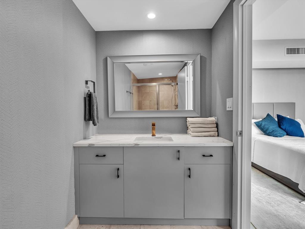 1600 South Ocean Boulevard, Unit 403 Pompano Beach, FL 33062 - Photo 24 of 52 a bathroom with a granite countertop sink and a mirror