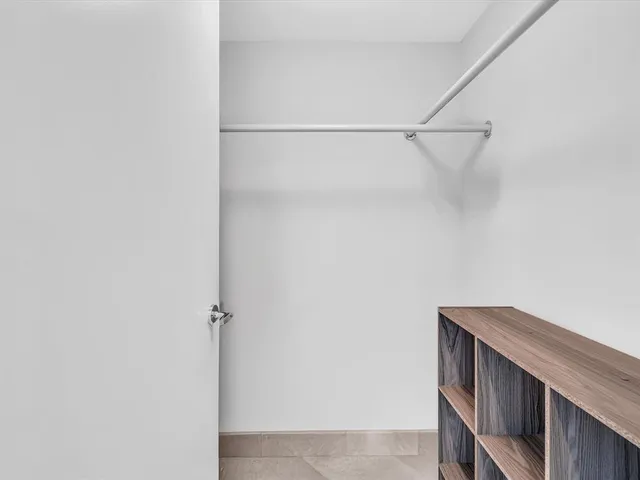 a living room with furniture and a view of kitchen
