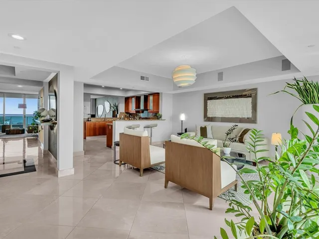 a kitchen with stainless steel appliances kitchen island granite countertop a table and chairs in it