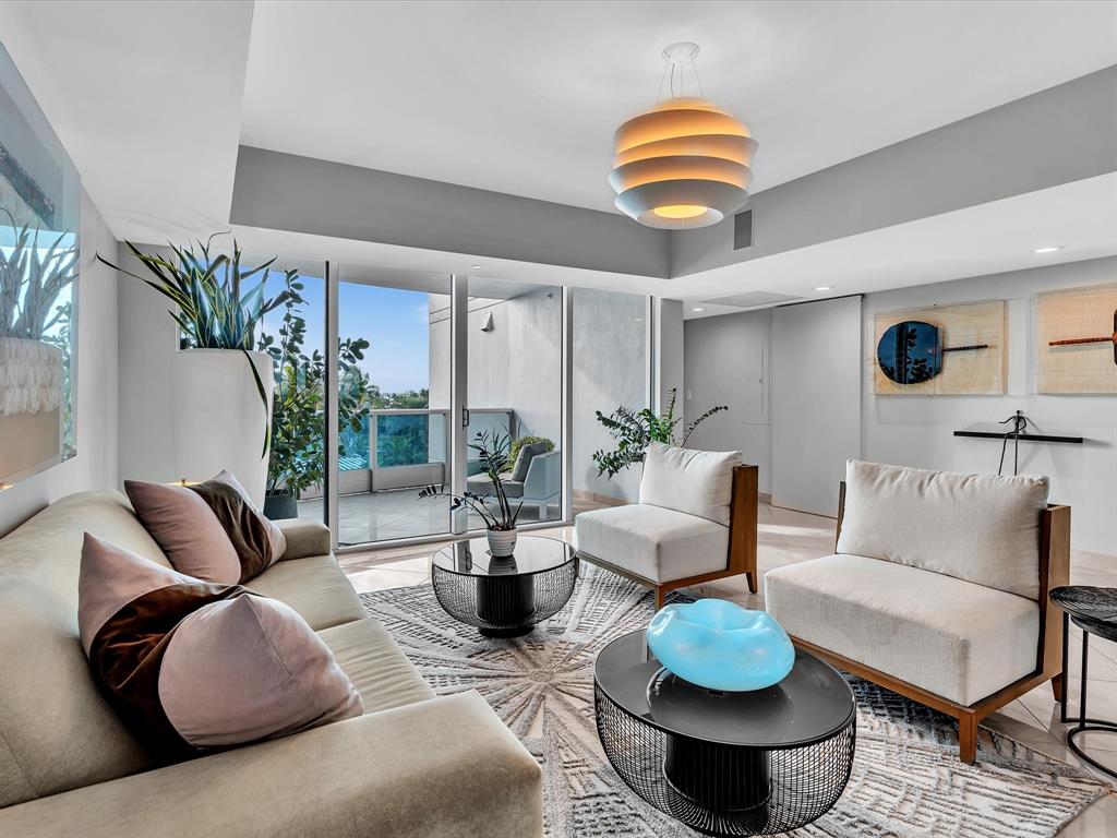 1600 South Ocean Boulevard, Unit 403 Pompano Beach, FL 33062 - Photo 32 of 52 a living room with furniture potted plant and a large window
