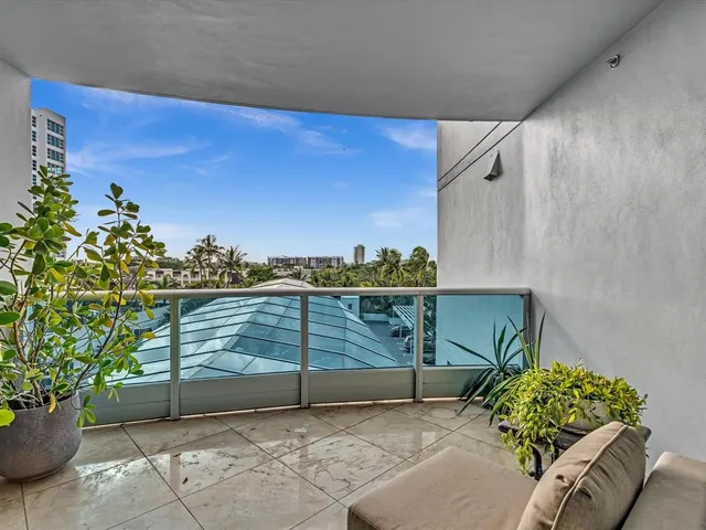 a view of a patio with a table and chairs