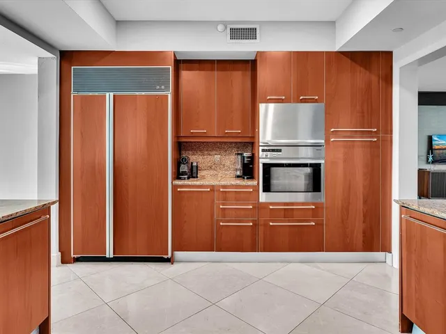a kitchen with stainless steel appliances granite countertop a refrigerator and a sink