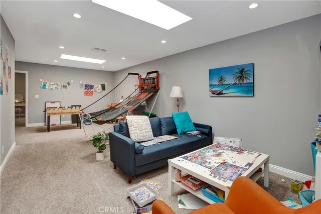 a living room with furniture a rug and white walls