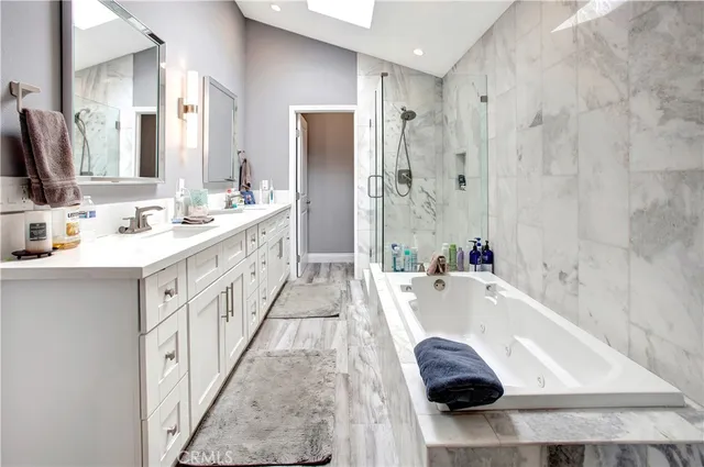 a bathroom with a tub sink and mirror