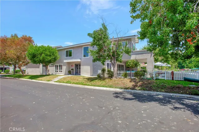 a view of a house with a yard and plants