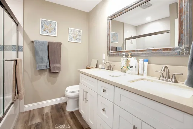 a bathroom with a sink a toilet and a mirror