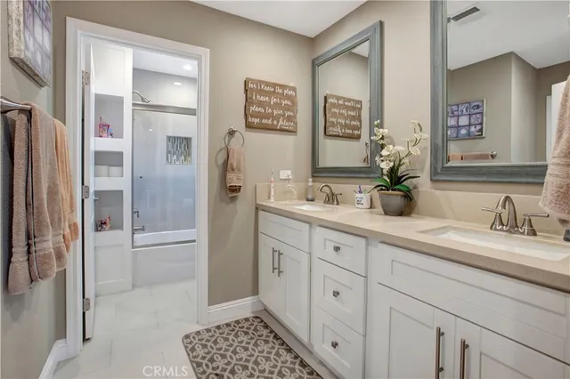 a spacious bathroom with a shower a sink and a mirror