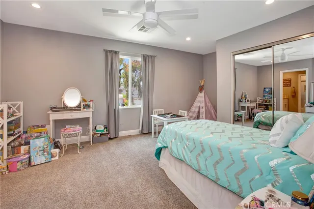 a bedroom with a bed and a tv in it