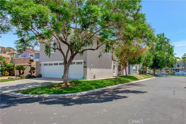 a yellow house with trees in front of it