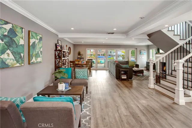 a living room with furniture fireplace and wooden floor