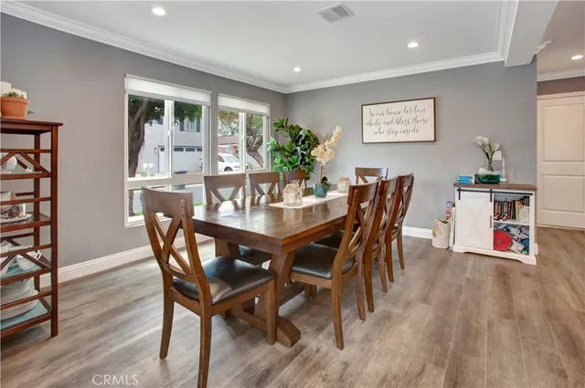 a dining room with furniture and wooden floor