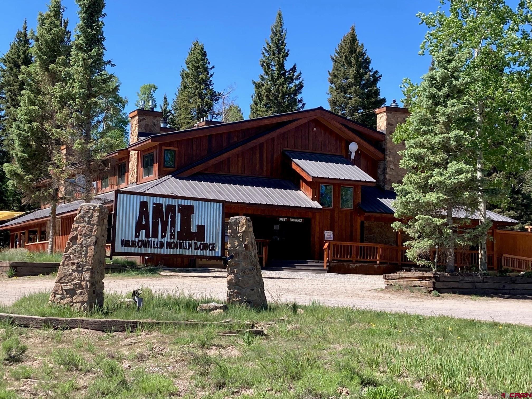 147 Ridge Road Cimarron, CO 81220 - Photo 21 of 36 a front view of a house with a yard