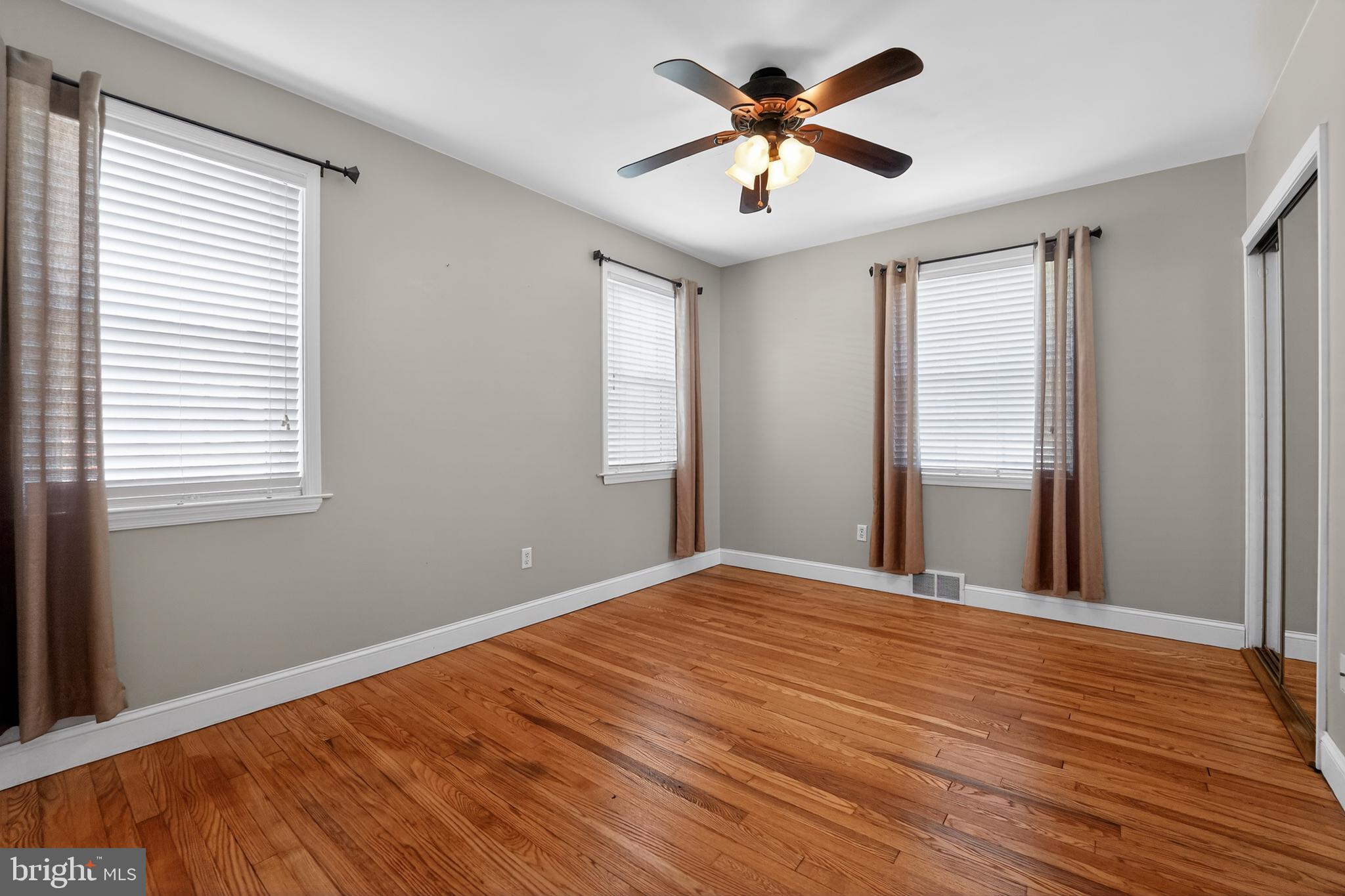 9408 Dana Vista Road Baltimore, MD 21236 - Photo 34 of 38 a view of empty room with wooden floor and fan