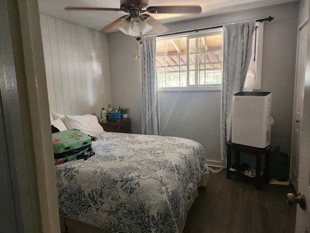 a bathroom with a granite countertop sink a toilet and a shower