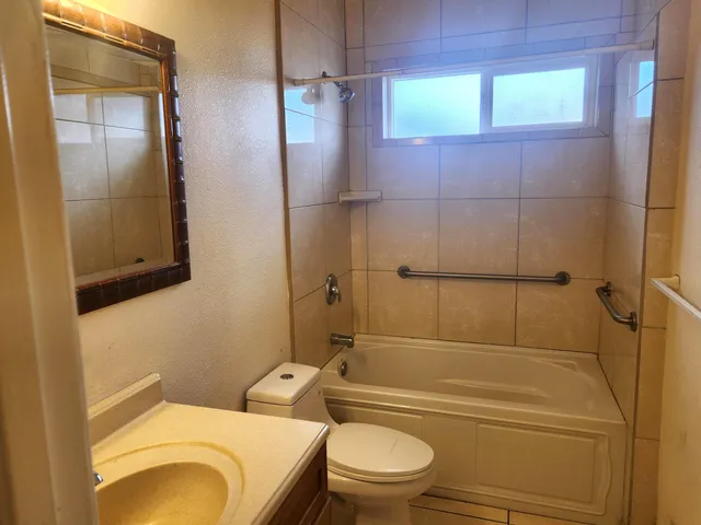 a bathroom with a toilet a sink and shower