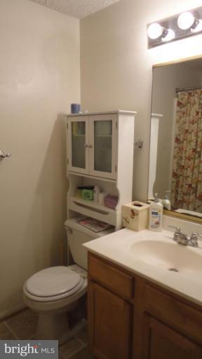 19517 Gunners Branch Road, Unit 432 Germantown, MD 20876 - Photo 4 of 6 a bathroom with a toilet sink and mirror