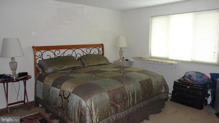 19517 Gunners Branch Road, Unit 432 Germantown, MD 20876 - Photo 5 of 6 a bedroom with a bed and a window