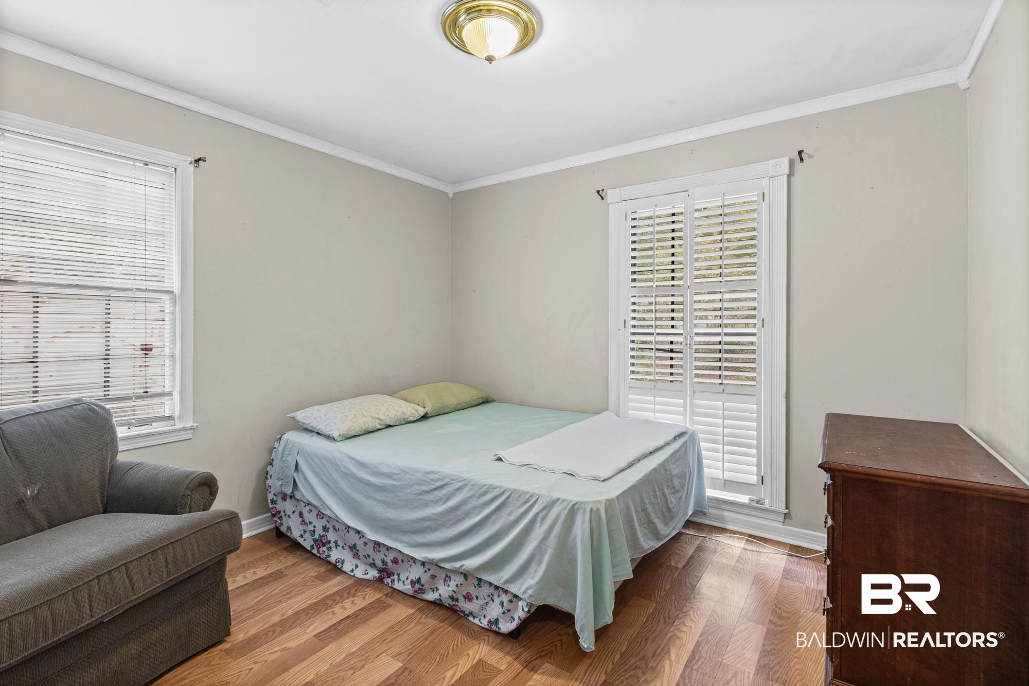 5510 Richmond Road Mobile, AL 36608 - Photo 10 of 21 Room with wood-finish flooring, neutral wall paint, and white crown molding