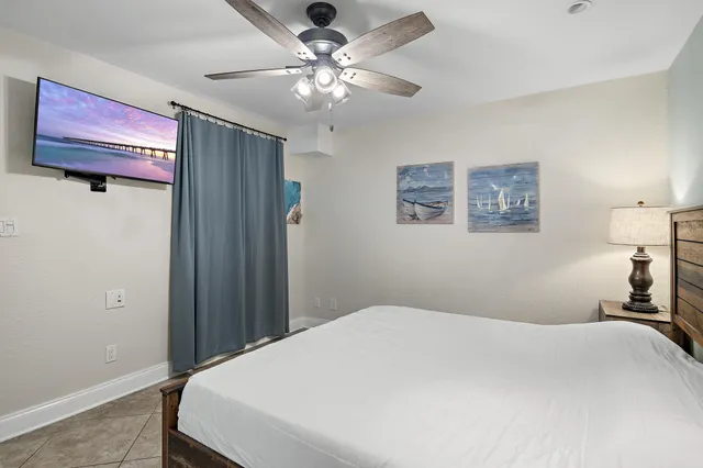 a bedroom with a large bed and a chandelier