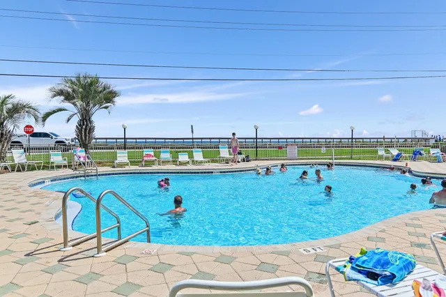 a view of swimming pool with outdoor seating