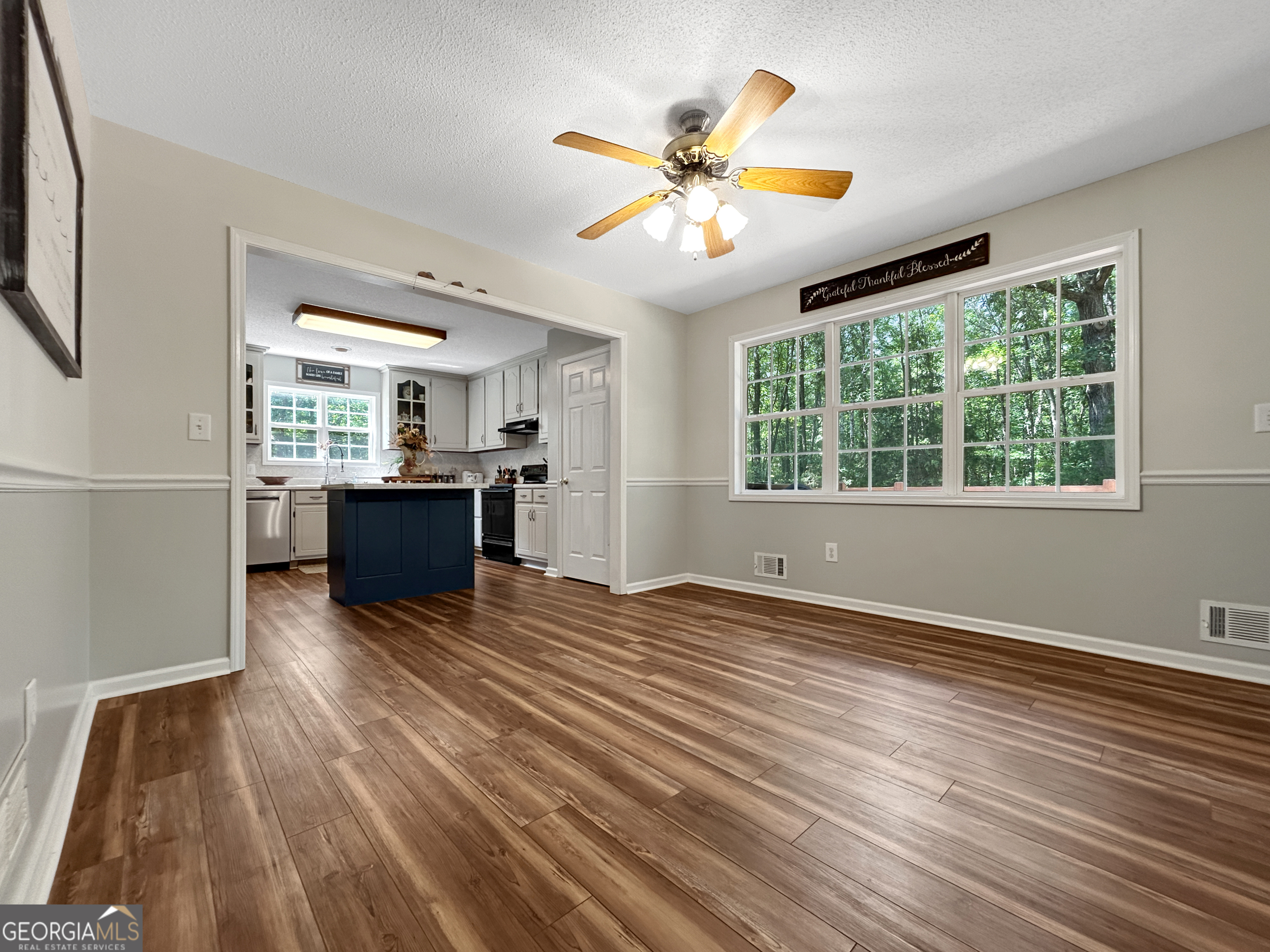 715 Frog Road Locust Grove, GA 30248 - Photo 11 of 56 a view of an empty room with a window and wooden floor