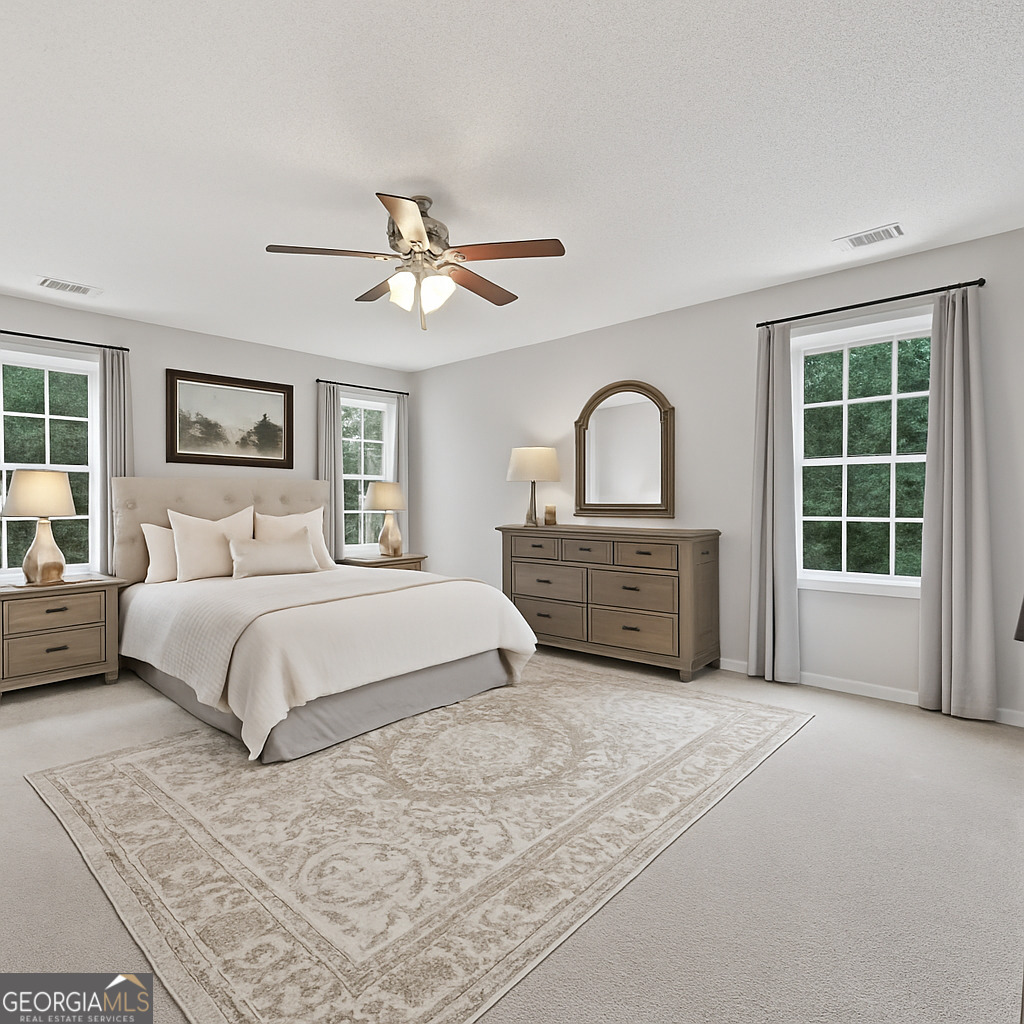 715 Frog Road Locust Grove, GA 30248 - Photo 24 of 56 a spacious bedroom with a large bed and a window