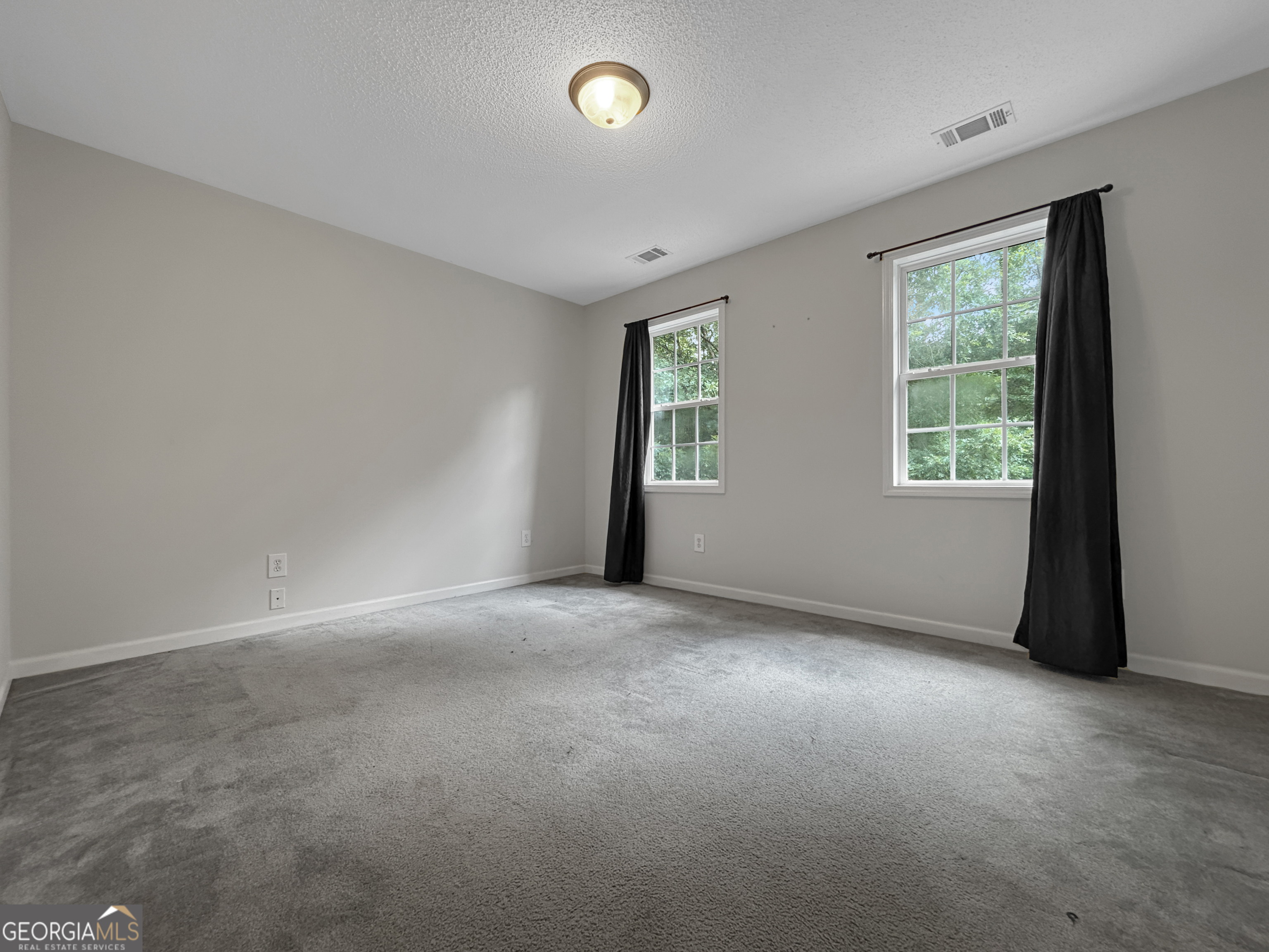 715 Frog Road Locust Grove, GA 30248 - Photo 27 of 56 an empty room with windows