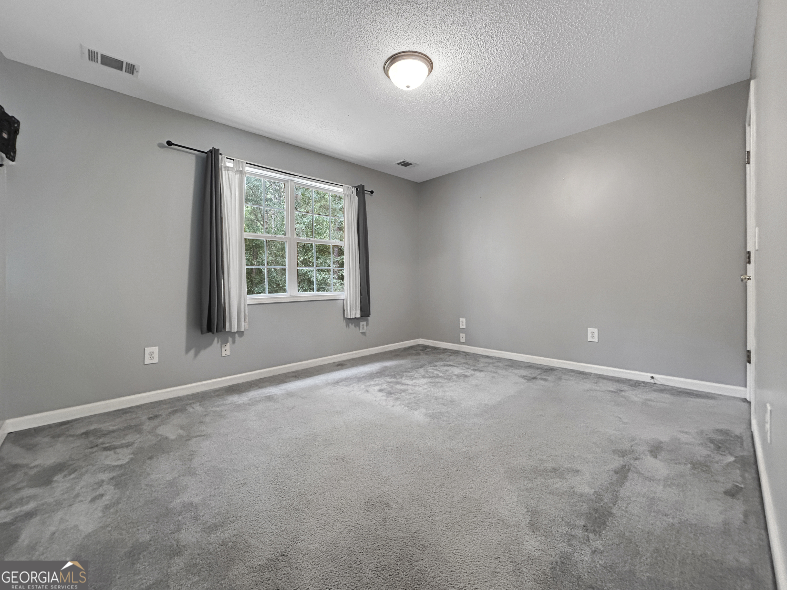 715 Frog Road Locust Grove, GA 30248 - Photo 30 of 56 an empty room with a window