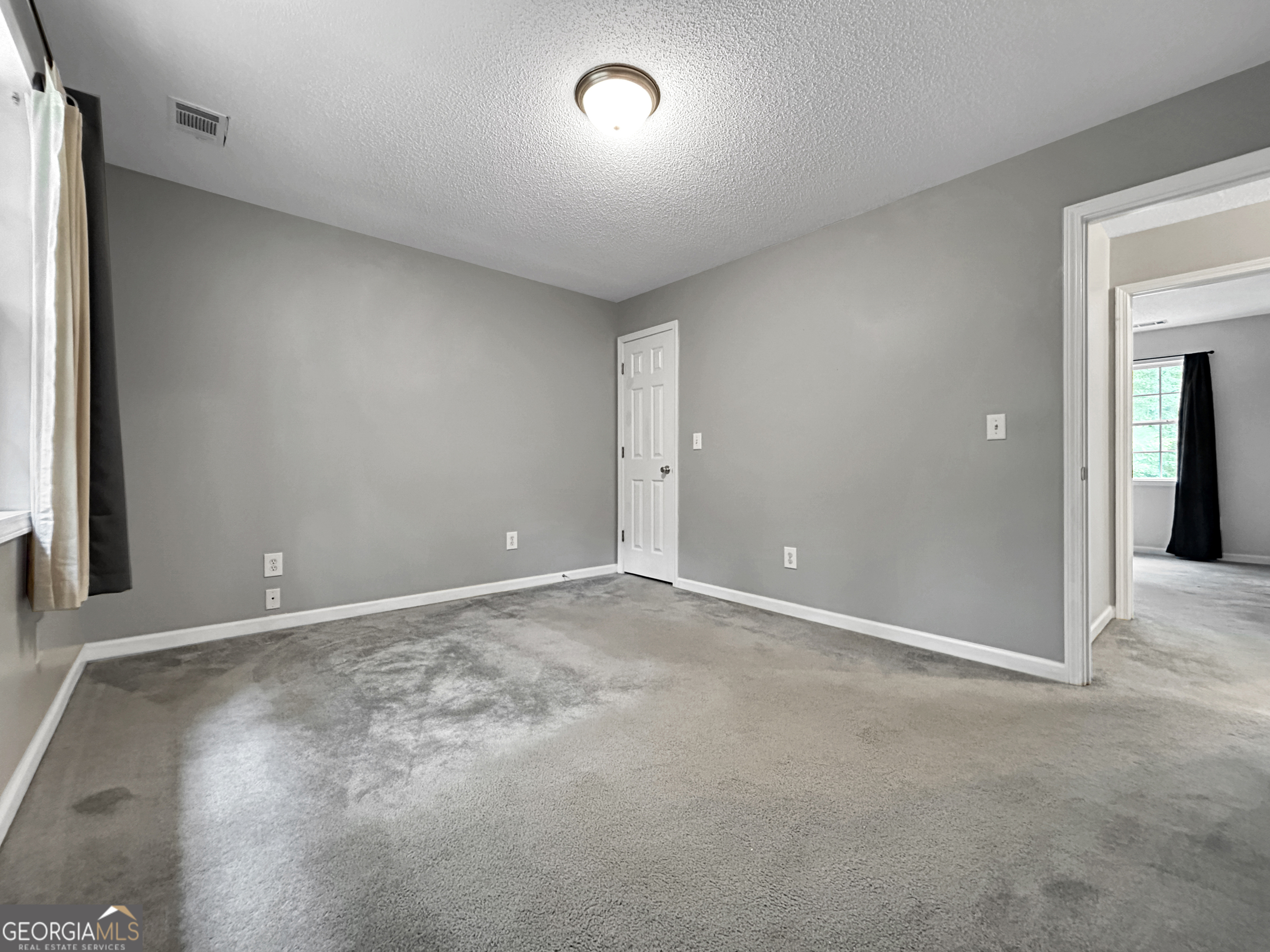 715 Frog Road Locust Grove, GA 30248 - Photo 31 of 56 an empty room with a empty space and windows