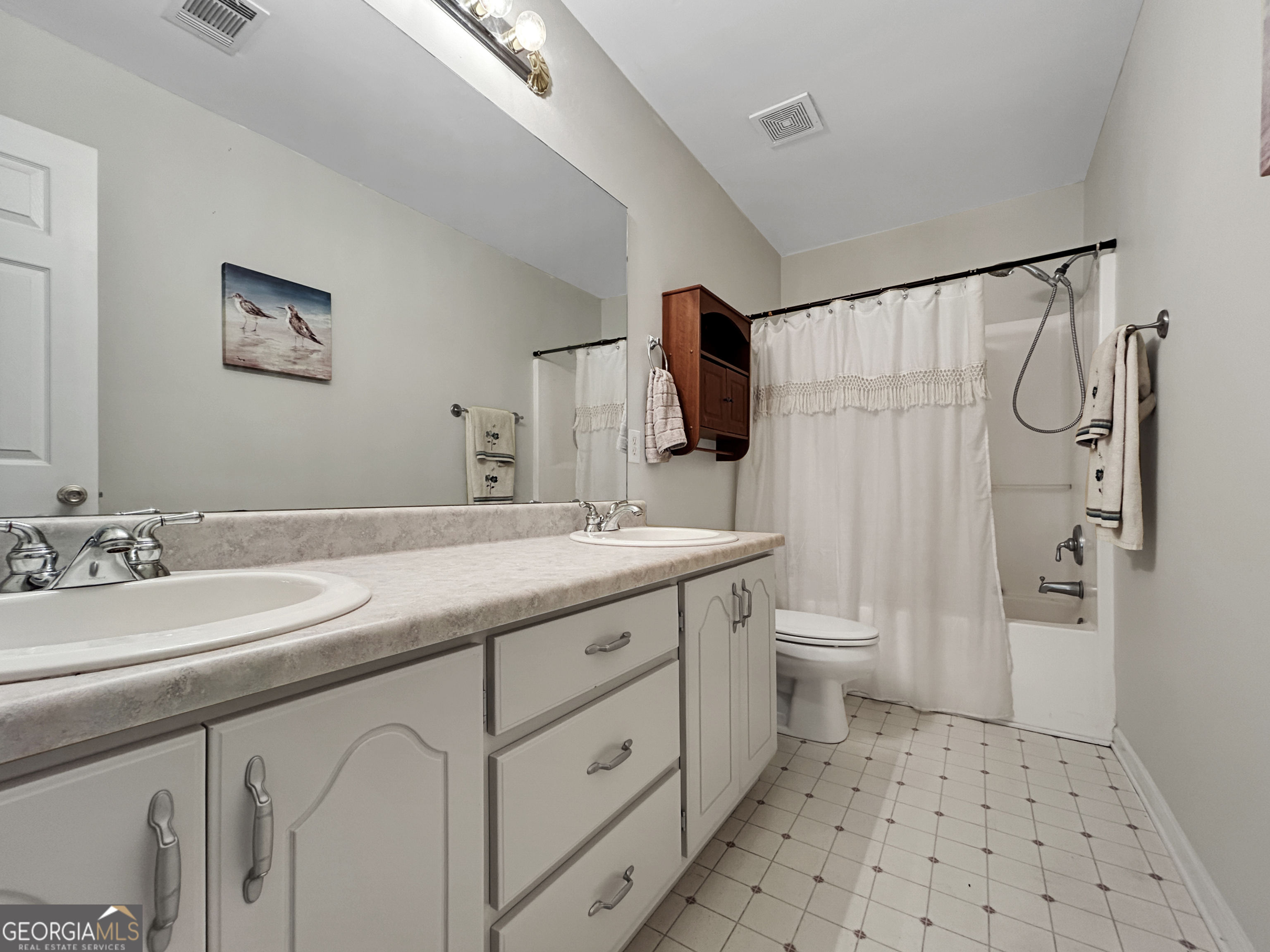 715 Frog Road Locust Grove, GA 30248 - Photo 33 of 56 a bathroom with a double vanity sink toilet and shower