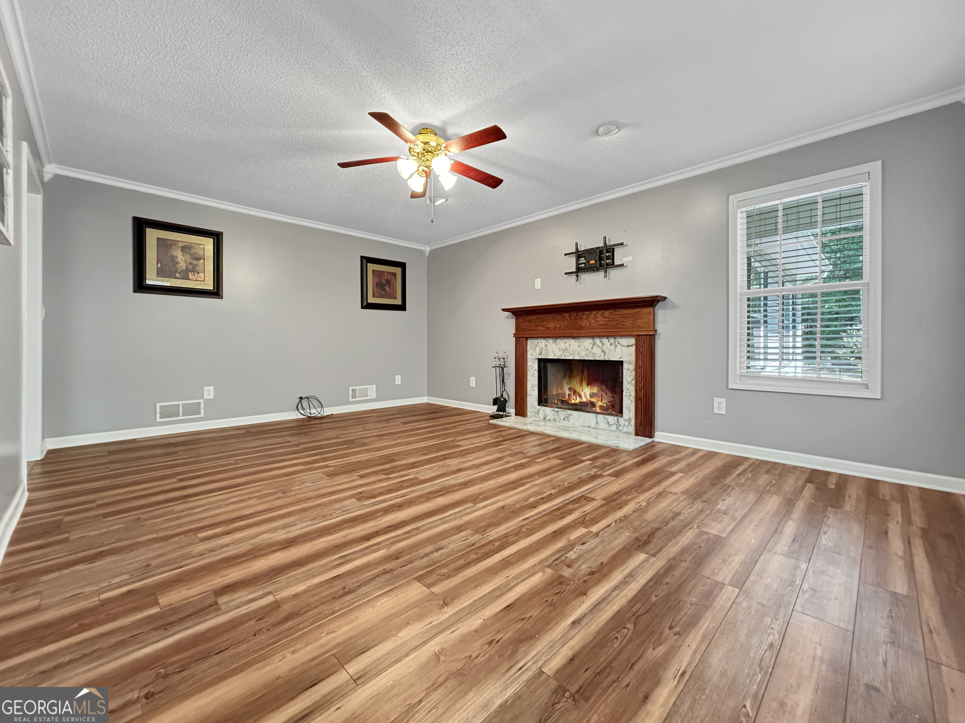 715 Frog Road Locust Grove, GA 30248 - Photo 6 of 56 a bedroom with a bed and a fireplace