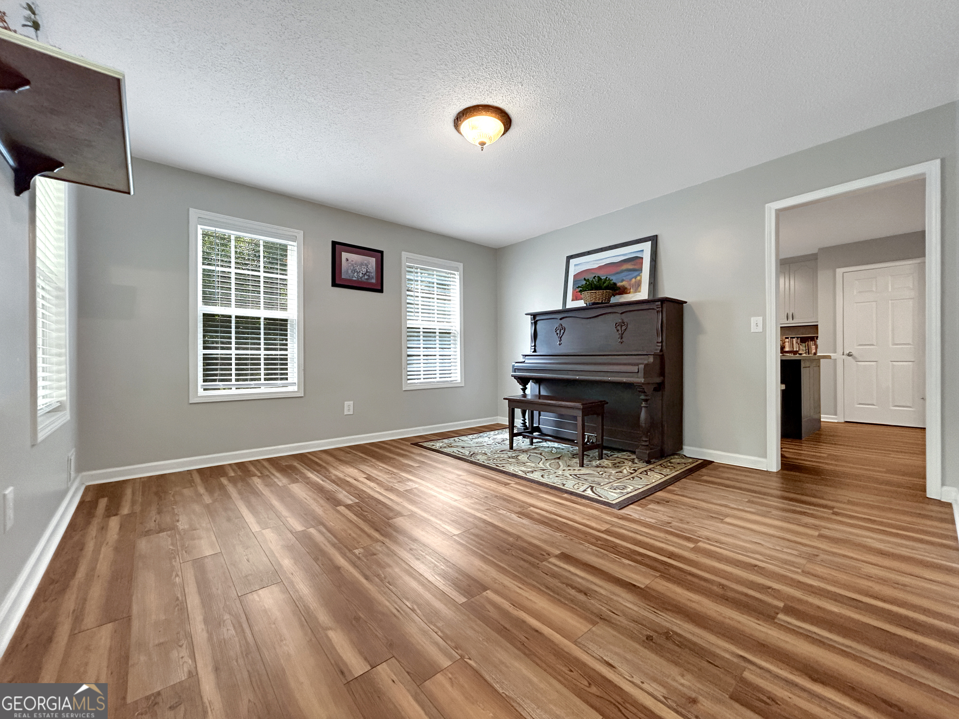 715 Frog Road Locust Grove, GA 30248 - Photo 8 of 56 a living room with furniture and a wooden floor