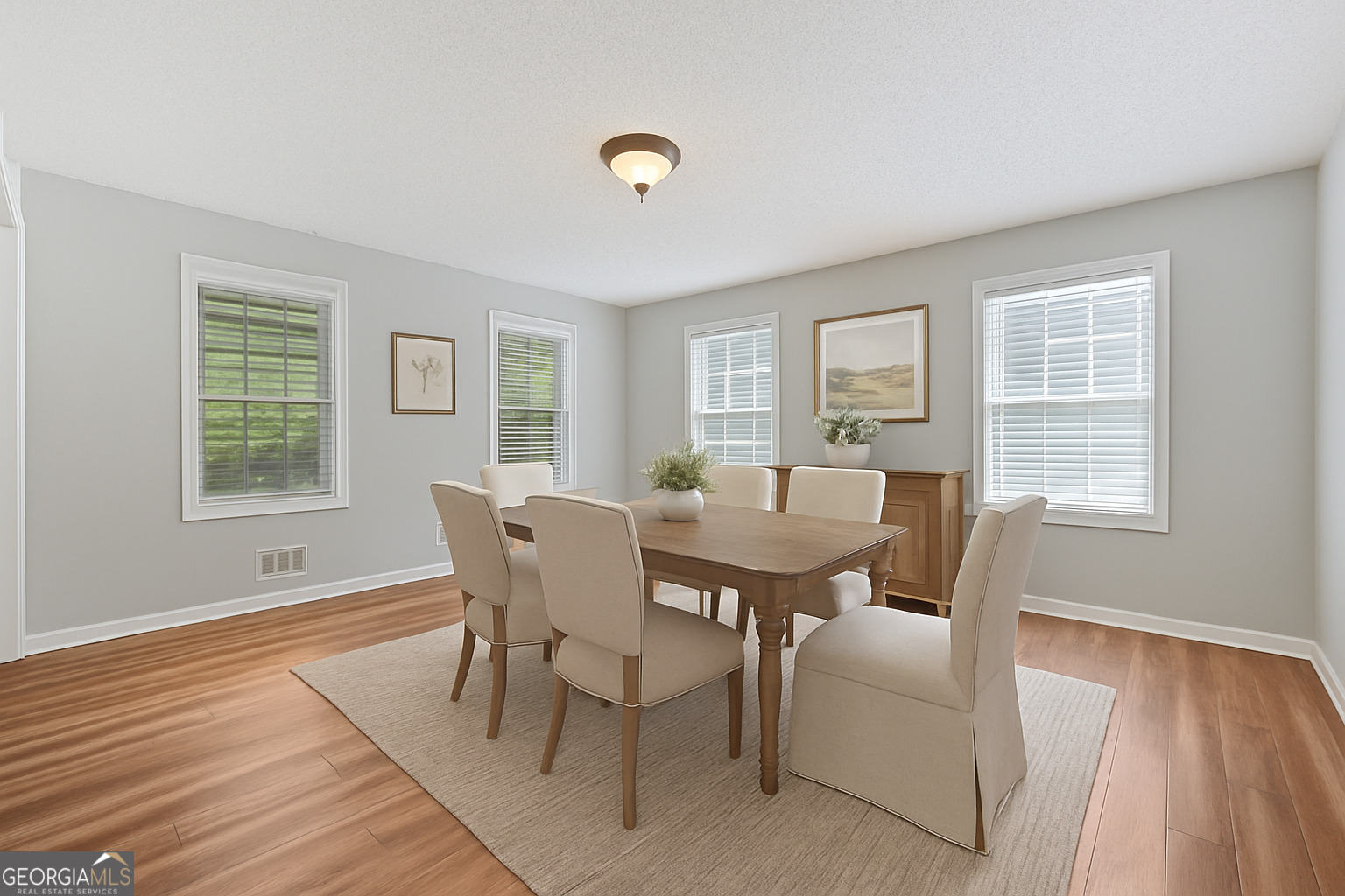 715 Frog Road Locust Grove, GA 30248 - Photo 10 of 56 a view of a dining room with furniture and wooden floor