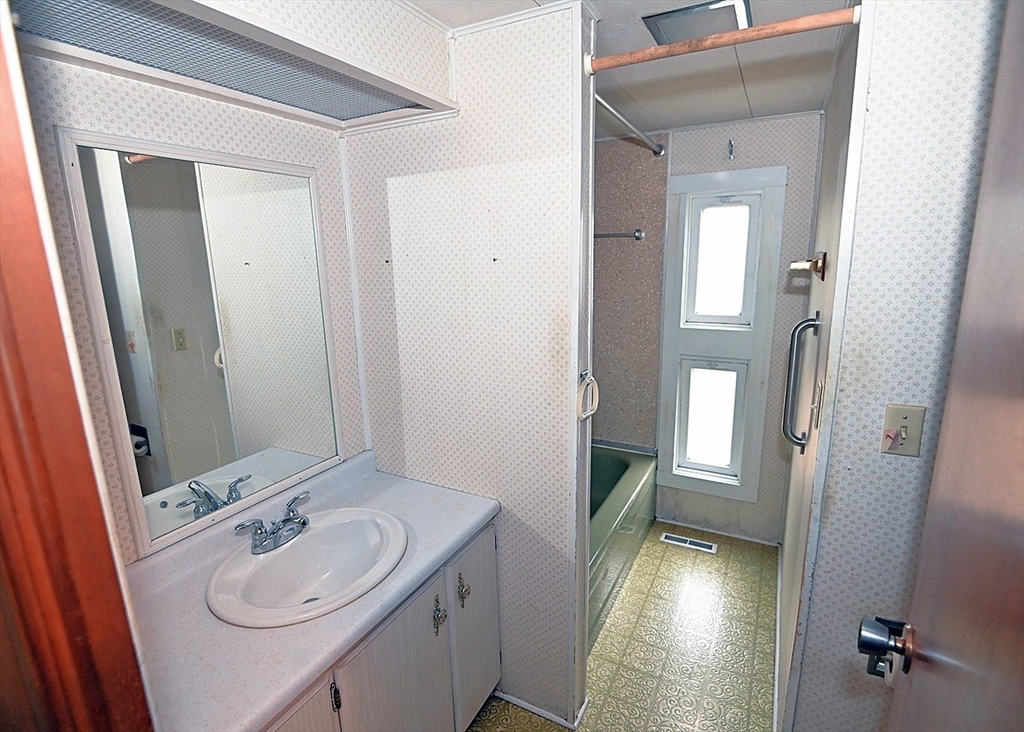 44 Great Hill Drive Wareham, MA 02576 - Photo 14 of 19 a bathroom with a sink a mirror and vanity
