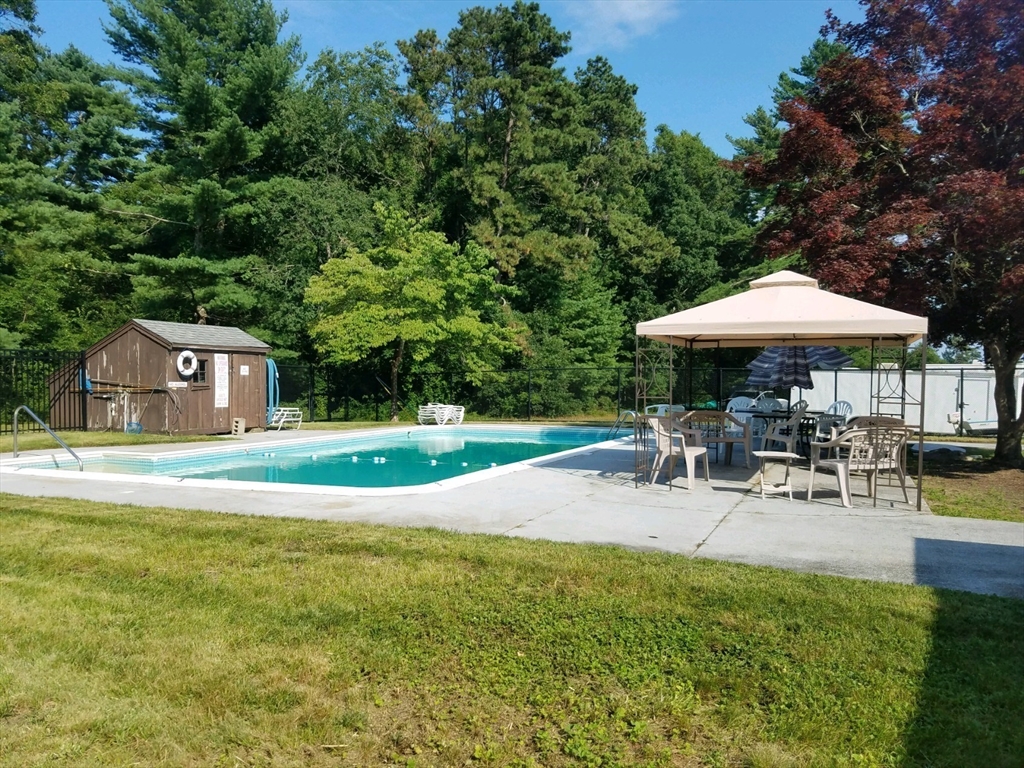 44 Great Hill Drive Wareham, MA 02576 - Photo 19 of 19 a view of pool with table and chairs under an umbrella