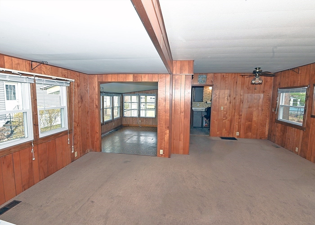 44 Great Hill Drive Wareham, MA 02576 - Photo 4 of 19 an empty room with a fireplace and windows