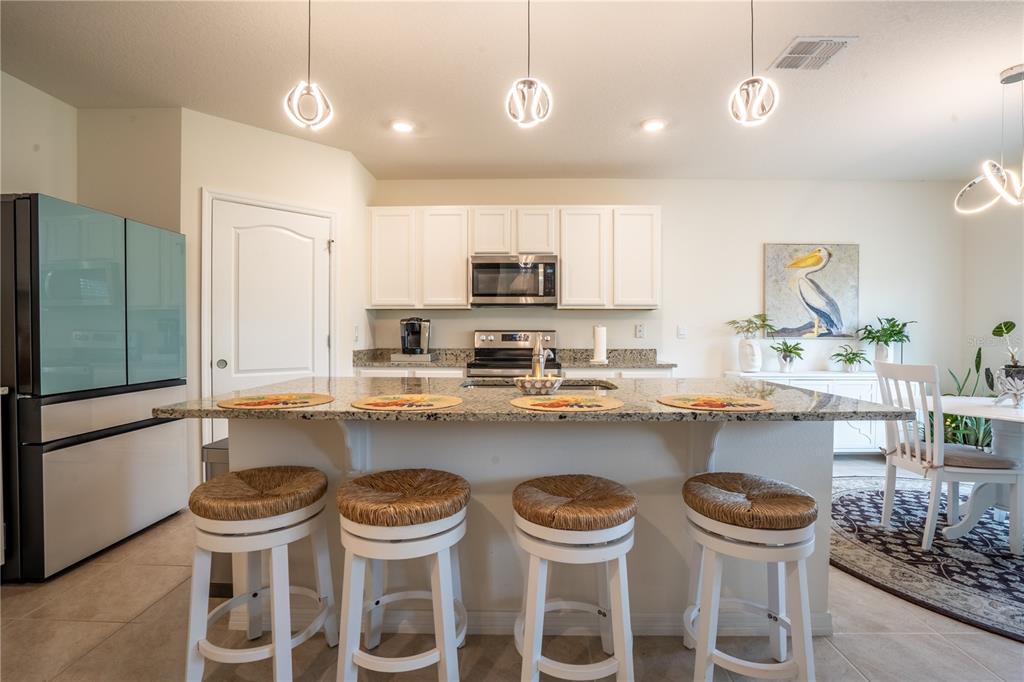 2540 Harmonia Hammock Road Harmony, FL 34773 - Photo 11 of 54 a kitchen with a table and chairs in it