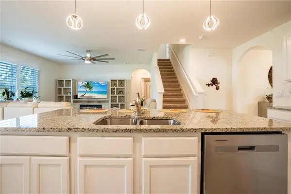 a view of center kitchen island a sink a window and living room view