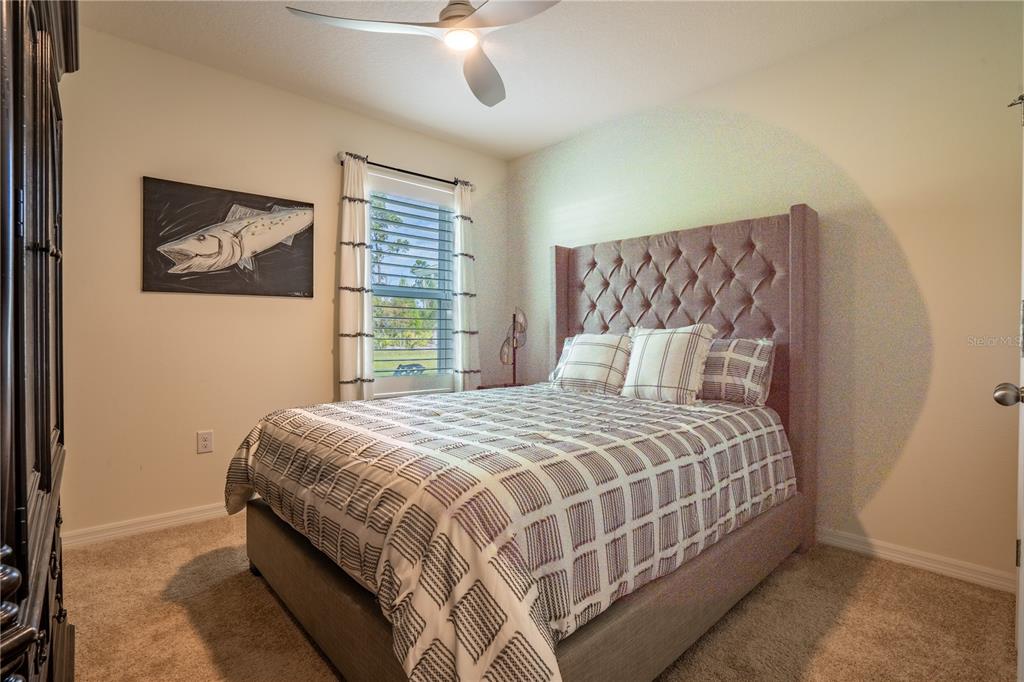 2540 Harmonia Hammock Road Harmony, FL 34773 - Photo 18 of 54 a bedroom with a bed and a painting on the wall