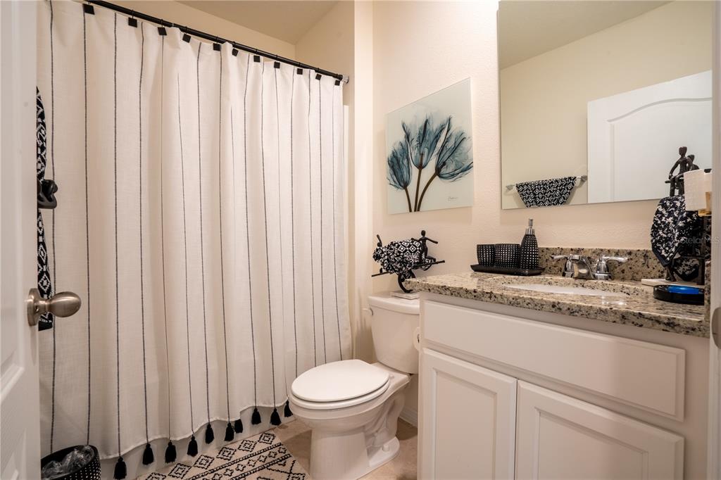 2540 Harmonia Hammock Road Harmony, FL 34773 - Photo 19 of 54 a bathroom with a sink a toilet and a mirror