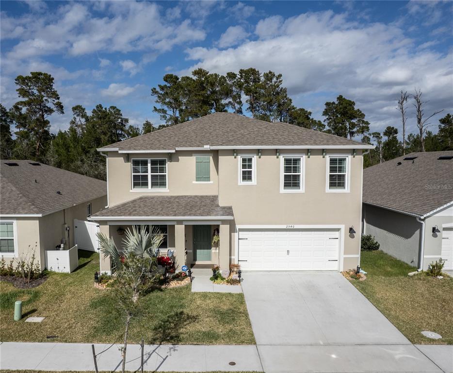 2540 Harmonia Hammock Road Harmony, FL 34773 - Photo 2 of 54 a front view of a house with garden
