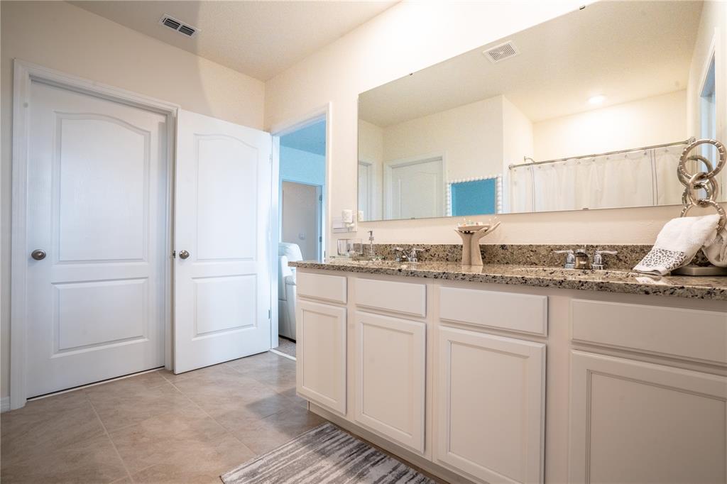 2540 Harmonia Hammock Road Harmony, FL 34773 - Photo 24 of 54 a kitchen with granite countertop white cabinets and white appliances