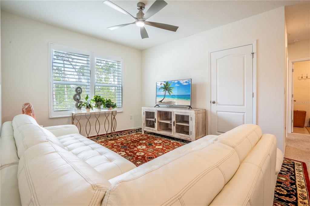 2540 Harmonia Hammock Road Harmony, FL 34773 - Photo 26 of 54 a living room with a bed furniture and a window