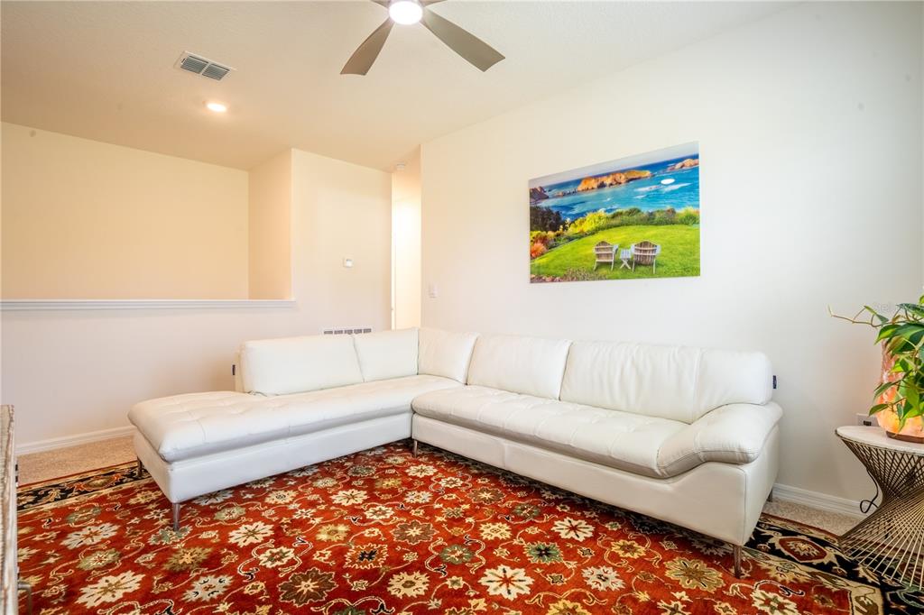 2540 Harmonia Hammock Road Harmony, FL 34773 - Photo 28 of 54 a living room with furniture and a rug
