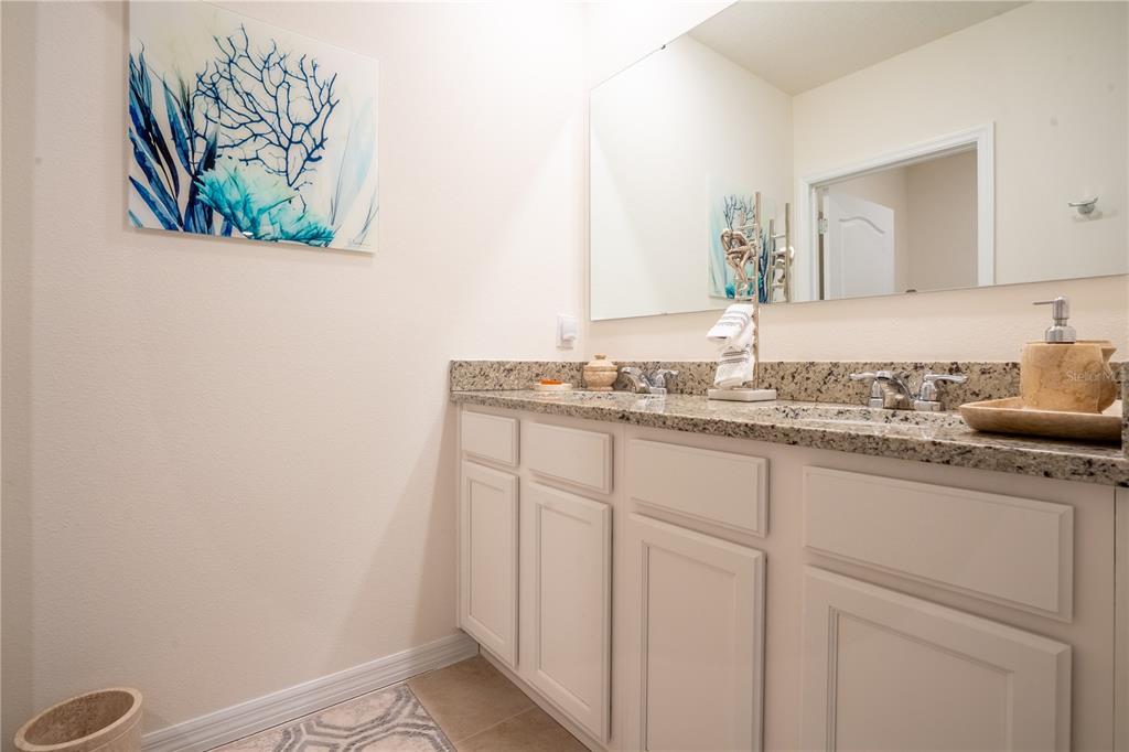 2540 Harmonia Hammock Road Harmony, FL 34773 - Photo 33 of 54 a bathroom with a sink a vanity and mirror