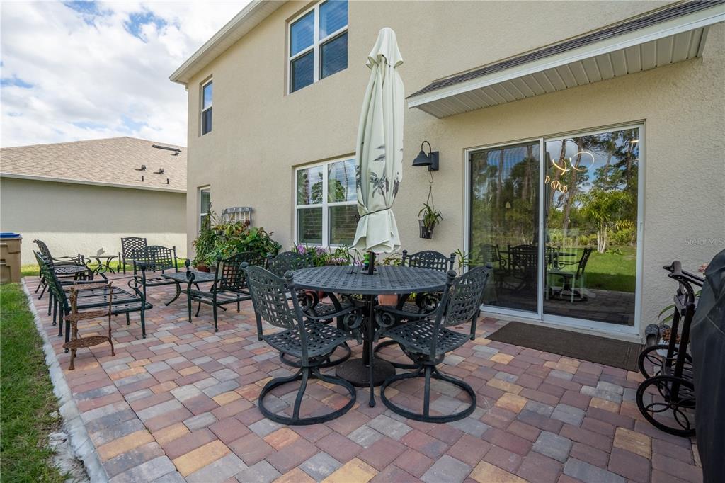 2540 Harmonia Hammock Road Harmony, FL 34773 - Photo 34 of 54 a view of a dinning tables and chairs in backyard of a house
