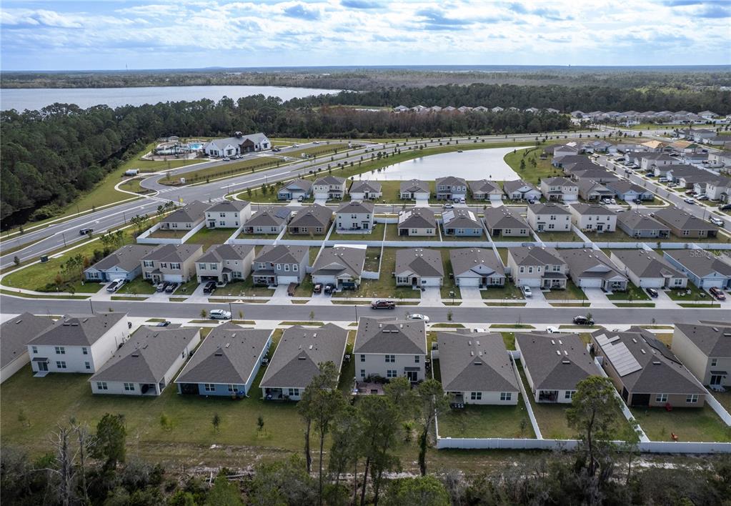 2540 Harmonia Hammock Road Harmony, FL 34773 - Photo 52 of 54 an aerial view of a house with a garden and lake view