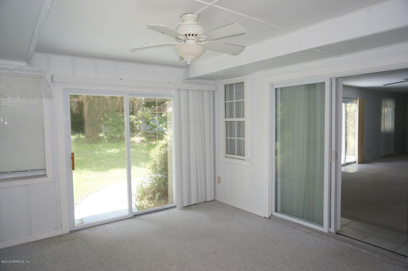 6511 Brooklyn Bay Road Keystone Heights, FL 32656 - Photo 11 of 25 an empty room with windows and outdoor view