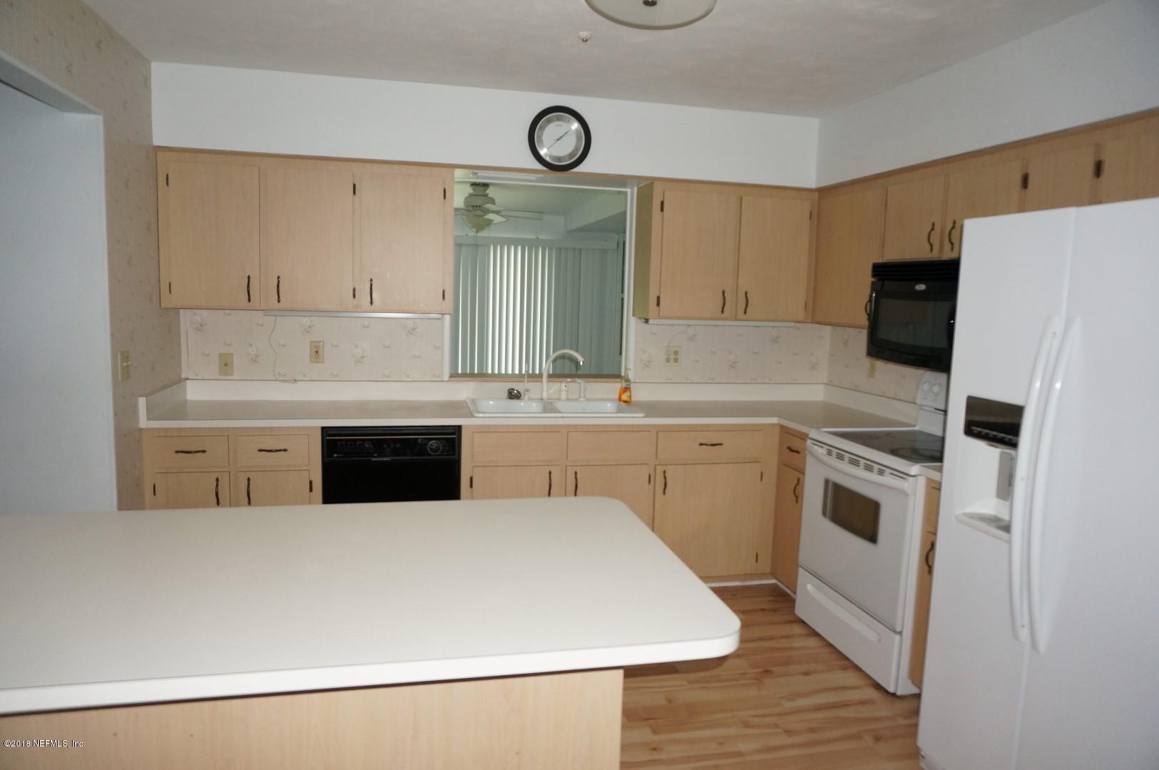 6511 Brooklyn Bay Road Keystone Heights, FL 32656 - Photo 7 of 25 a kitchen with a sink a stove a refrigerator and a window