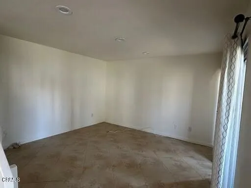 a view of an empty room and a window